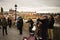 Prague, Czech Republic: street musicians are playing music on the Charles Bridge near a lamppost