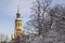 Prague Loreta Belltower among snowy trees