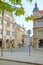 Prague street with a clock and old houses