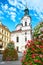 Prague in Summer with beautiful red and white flower arrangements by St. Nikolas Church at Stare Mesto or Old Market Square in