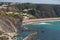 Praia da Arrifana beach with surfers on the atlantic ocean