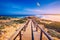 Praia da Bordeira and boardwalks forming part of the trail of tides or Pontal da Carrapateira walk in Portugal. Flying seagulls