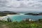 Praia das Conchas, with beautiful sky and mountains in the background.