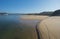 Praia das Furnas sand beach with view over the Mira river to Vila Nova de Milfontes, Vicentine Coast Natural Park