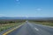 Prairie Landscape with Mountains, Highway and Campervan