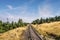 Prairie landscape with a railroad under a blue sky