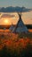 Prairie tranquility Indian teepee in field at sunset, First Nations