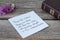 Praise the LORD, handwritten verse on a note, closed Holy Bible Book on wood