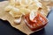 Prawn Crackers or Shrimp Chips with ketchup served on parchment paper, Fresh Krupuk on dark background