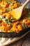 Prawns in curry sauce in a frying pan macro. vertical, rustic