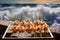 prawns on grill with ocean waves in background