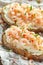 Prawns, shrimp seafood bruschetta with creamy cheese, parsley and chili