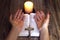 Pray. Female hands near the bible and candles on a wooden table