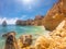 Praya de Marinha most beautiful beach in Algarve, Portugal. Cliffs on Coast of Atlantic ocean against blue sky