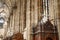 Prayer booth. Gothic architecture. Hall of the cathedral. Cross on a wooden base with patterns. Wimperg.