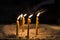 Prayer burning candles in a church on a dark background. Religious concept