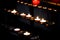 Prayer candles lit inside a church as a votive offering in an act or prayer