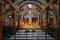 Prayer hall of Sri Dharmarajika Chetiya Vihara, with walls and curved ceiling covered in brightly-colored murals