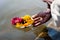 Prayer hands leaving flower offer on the river