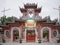 Prayer inside a Buddhist Taoist temple in Vietnam, Buddha statue worship in an ancient temple in Hoi An tourist city