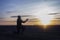 Prayer. Man on his knees praying. Against the background of the sky and sunset. Forgiveness of sins and repentance.