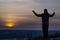 Prayer. Repentance. A man with his hands raised against the sky. Pray to God. Worship, against the backdrop of sunset