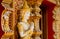 Praying Buddha at the entrance of a traditional Thai temple