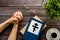 Praying concept with hands, Holy Bible, Ortodox cross on wooden background top-down. Copy space