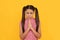 Praying girl child pray holding palms together in prayer gesture yellow background, plead