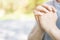 Praying hands of faithful mature young man hands folded in worship on a outdoor