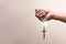 Praying hands hold a crucifix or cross of metal necklace with faith in religion and belief in God on confession background. Power