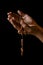 Praying hands of an old Indian Catholic woman with wooden rosary