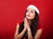 Praying happy woman in santa claus christmas costume looking up