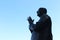 Praying metal statue and blue sky - Pray peace