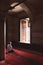 Praying muslim man in the mosque. Ramadan or islamic vertical photo.