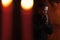 Praying priest. Portrait of priest Next to the candles prays