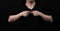 Praying with a rosary. hand of Catholic man with rosary on black background