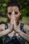 Praying Sign. Young woman with jointed hands in a prayer or meditation.