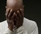 praying to god Caribbean man praying on black background with people stock image sock photo