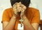 Praying young woman  with bowed head, hands holding rosary beads with Jesus Christ Cross or Crucifix. Christian Catholic religious