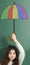 Pre-adolescent child holding painted colored umbrella