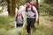 Pre-teen boy and his father hiking in a forest, selective focus