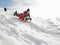 Pre-teen Boy On A Sled In The Snow