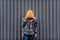 Pre-teen boy on a street in a big city next to a high-rise building alone.