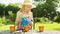 Pre teen caucasian girl watering flower pots in a garden