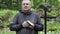 Preacher with Bible and rosary at outdoors church