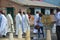 Preachers in church robes walk down the street during a festive procession