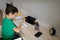 Preadolescent schoolboy, clever child studying at home, doing his homework, sitting at a wooden desk in front of a digital tablet