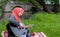 Preaty young muslim girl traying to play guitar on the river bank