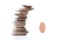 Precarious stack of coins falling